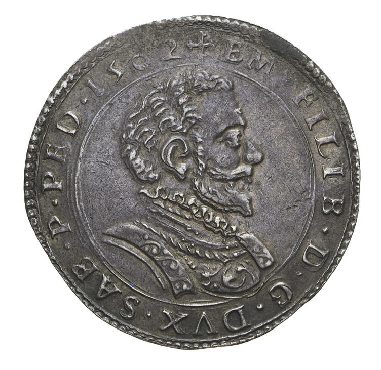 Il dritto delle lire in argento tipo INSTAR OMNIVM, le prime lire di Savoia coniate effettivamente, con il busto del duca Emanuele Filiberto Testa di ferro